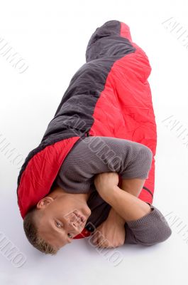young man covered himself with red sleeping bag
