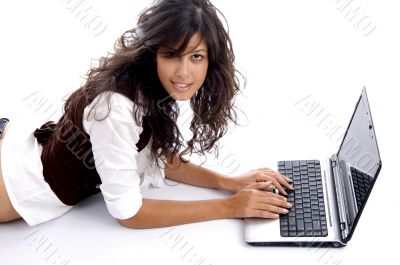 female operating laptop and looking at camera