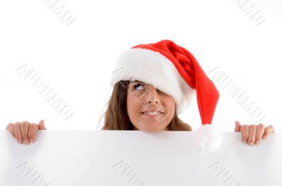 female wearing christmas hat and holding placard