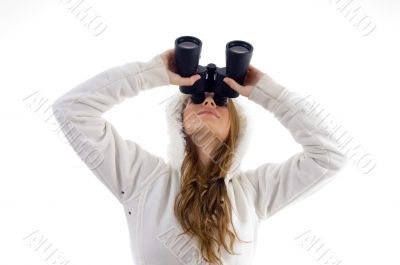 female watching upward through binocular