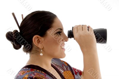 side pose of female watching through binocular