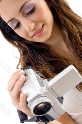 professional woman looking video into handy cam