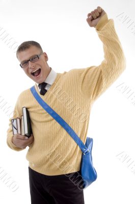 happy young student standing with books and bag