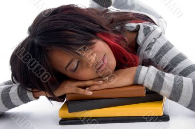 tired school girl sleeping with her books