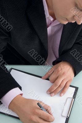 businessman writing on writing pad businessman writing on writing pad