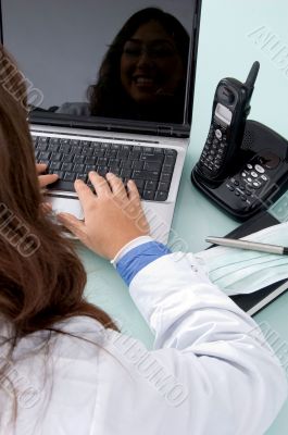 half length view of doctor working on laptop