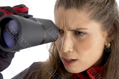 female viewing through  binoculars