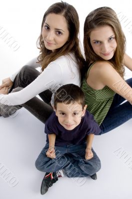 young kid sitting with teenagers