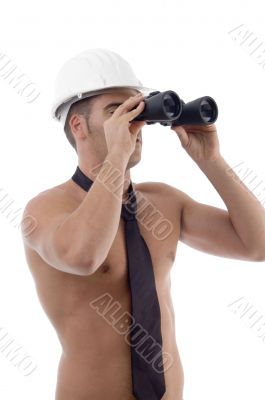 muscular architect looking through binocular