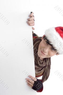 boy wearing christmas hat and holding placard
