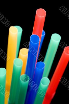 drinking straws on black close up