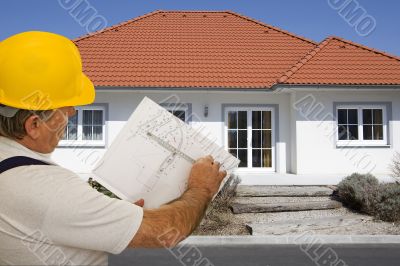 Construction worker with plan of an architect