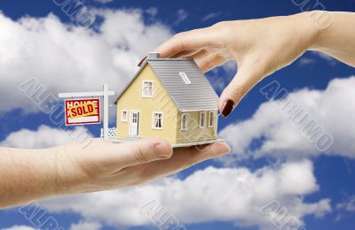 Reaching For A Home with Sold Real Estate Sign