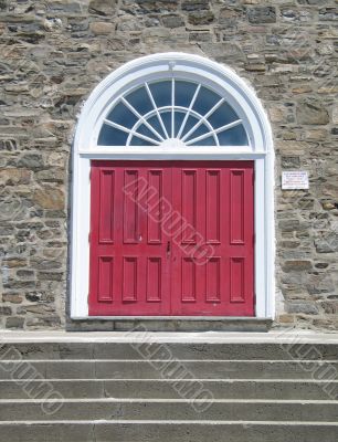 red door on a stone wall
