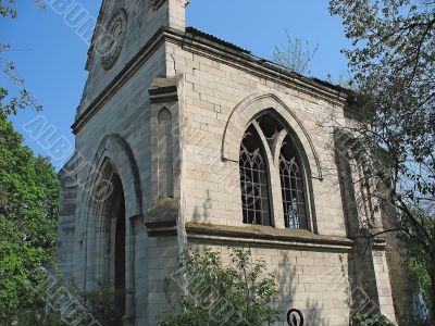 Deserted abandoned old church over with green bushes Deserted abandoned old church over with green bushes