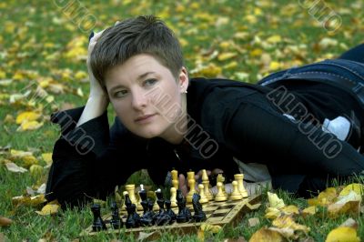 Charming woman with the chess board