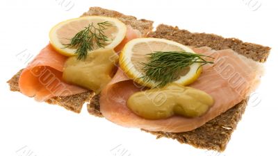 Salmon garnished on wholemeal bread