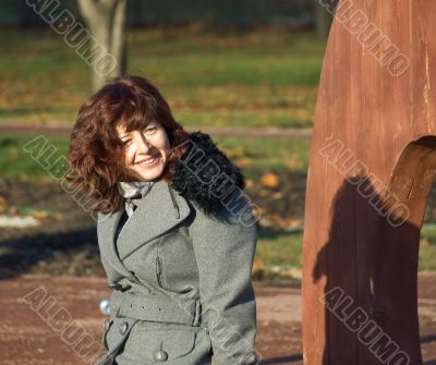 Joyful young woman in the autumn garden