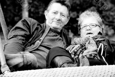 Older couple on the swing Older couple on the swing