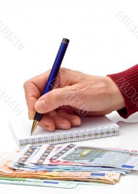 Hand, pen, notebook and money