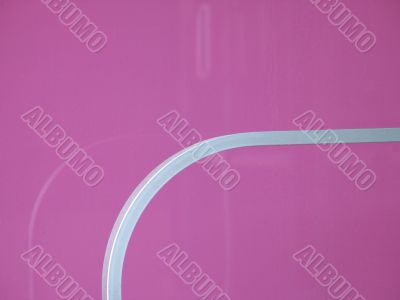 silver railing on a pink wall