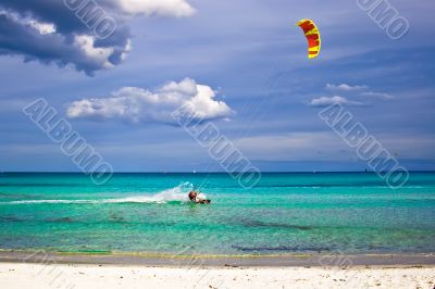 kitesurfer and white sandy beach