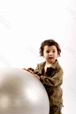 Little boy with big silver ball