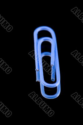paper clip on black blue