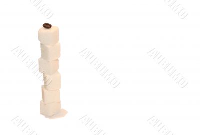 Coffee bean on the sugar pyramid Coffee bean on the sugar pyramid