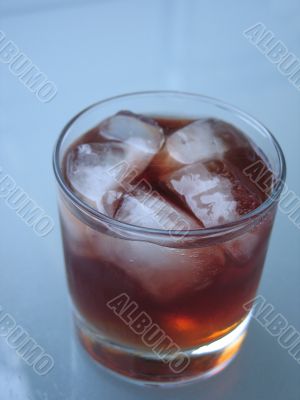 drink with ice on a glass table