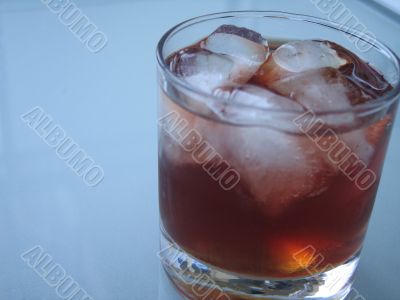 drink with ice on a glass table