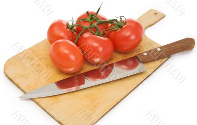 Knife and branch tomatoes