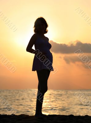Pregnant woman at sunset