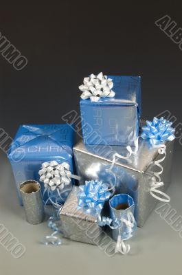 stock of blue and silver wrapped christmas presents with ribbons