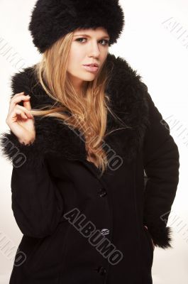 Woman in black fur hat and coat