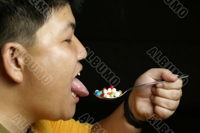 Asian man eating pills