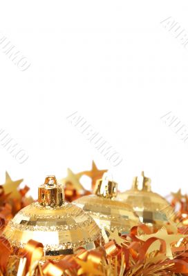 Gold Christmas baubles in tinsel