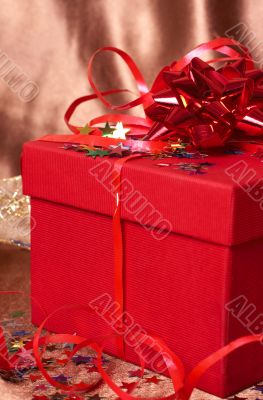 Red gift box with bows and stars