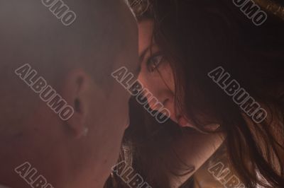 Loving couple in bright light looking into each others eyes