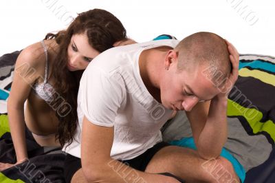 Girlfriend comforting her boyfriend who looks troubled