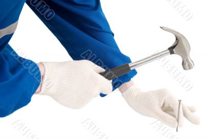 Male hand with hammer and nail