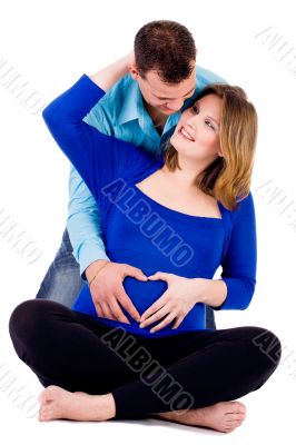 Pregnant couple with a heart shape