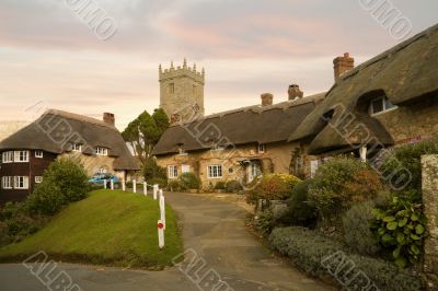 Idyllic hamlet of thatched cottages at sunset