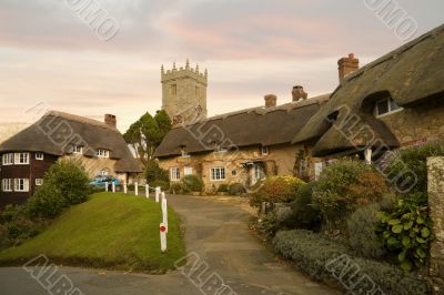 Idyllic hamlet of thatched cottages at sunset Idyllic hamlet of thatched cottages at sunset