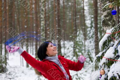  Joyful girl decorates a firtree
