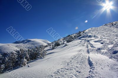 Shining sun in winter mountains