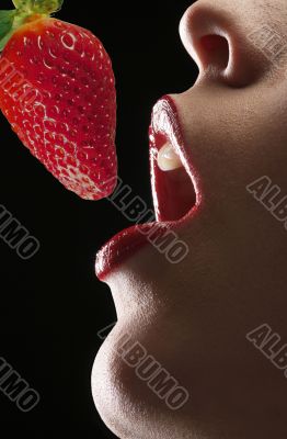 A girl and a strawberry