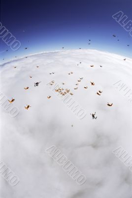 Skydiving Formation Above the Clouds