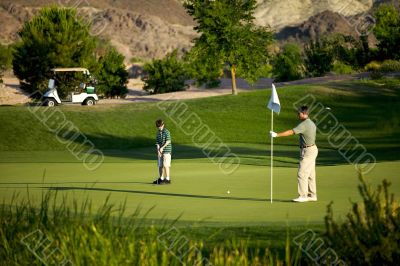 father and son on golf course