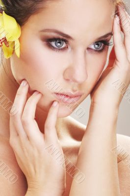 happy young woman with yellow flover on white background